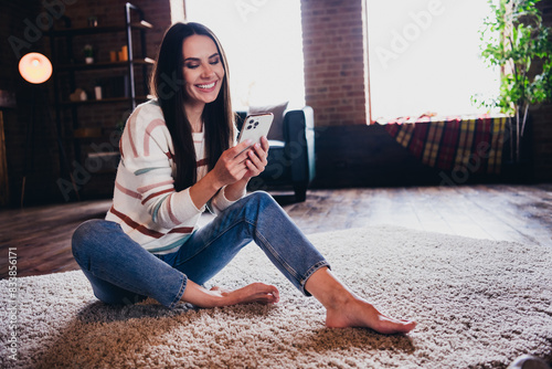 Photo of funny charming lady dressed striped sweater sitting floor communicating modern gadget indoors house room © deagreez