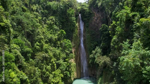 4K Aerial Drone video of beautiful Mantayupan Falls surrounded by jungle with a suspension bridge on a sunny day, Cebu, Philippines photo