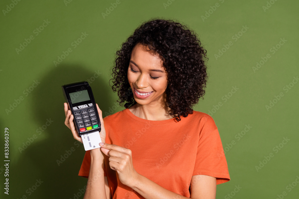 Photo portrait of lovely young lady pay credit card terminal dressed stylish orange garment isolated on khaki color background Photo portrait of lovely young lady pay credit card terminal dressed stylish orange garment isolated on khaki color background