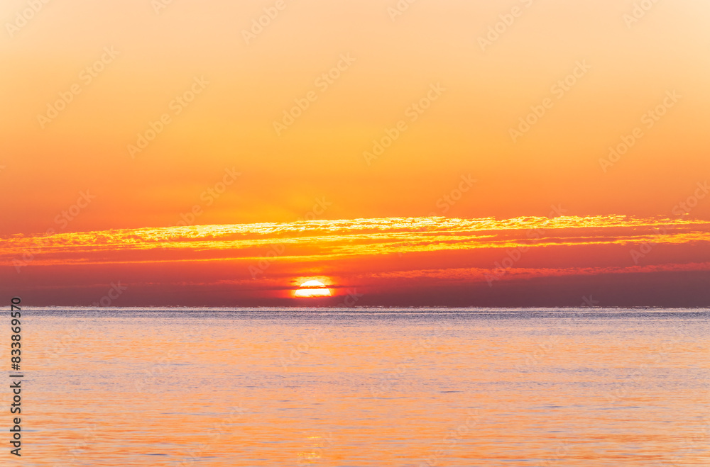 Obraz premium Beautiful red and orange sunrise over the sea.
