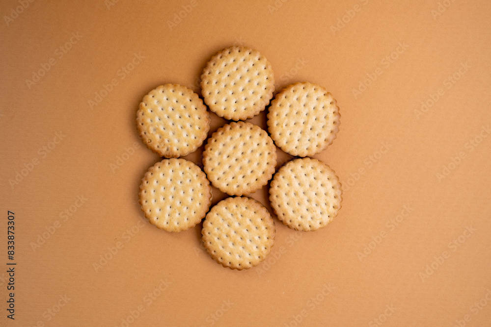 Sandwich cookies, chocolate cream filled biscuit stuck on brown yellow background. Modern cookies concept.
Sandwich cookies, chocolate cream filled biscuit stuck on brown yellow background. Modern cookies concept.