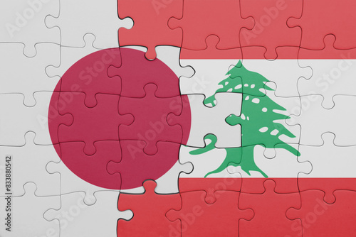 puzzle with the colourful national flag of lebanon and flag of japan. photo