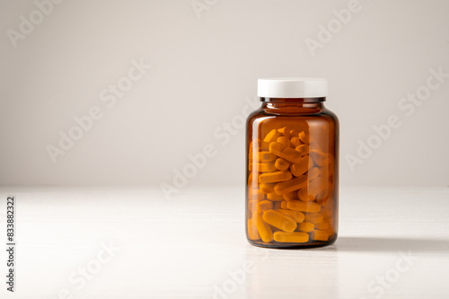Obraz na plátně White pills in brown glass jar, food supplements, drugs, antibiotics