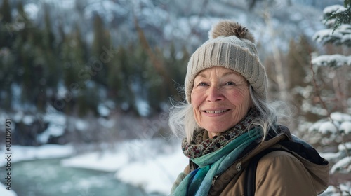 Embracing the Golden Years: A Joyful Senior Woman Hiking Through Scenic Winter Mountains