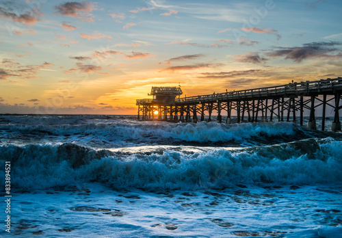 Cocoa Beach Pier on the beach with waves at sunrise photo