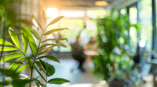 Blurred background of people in an office with abundant plants and natural light, showcasing eco-friendly business operations with copy space