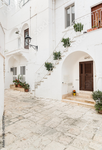 Characteristic narrow streets in the Locorotondo, metropolitan city of Bari, in Puglia, Italy