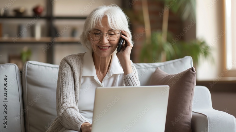 Senior elder woman lady making phone call in front of the laptop at home, concept of communication, wire scam, fraud,mature successful lady working from home, businesswoman hold meeting via video call Senior elder woman lady making phone call in front of the laptop at home, concept of communication, wire scam, fraud,mature successful lady working from home, businesswoman hold meeting via video call