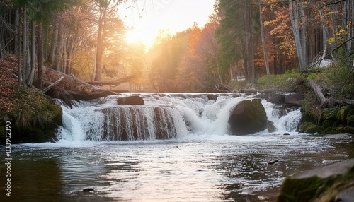 waterfall flowing in autumn forest at national park during warm sunset light cascade in woods with colorful trees and fresh water