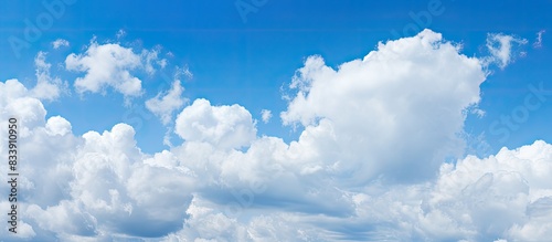 Blue sky backdrop with white clouds, ideal for copy space image.