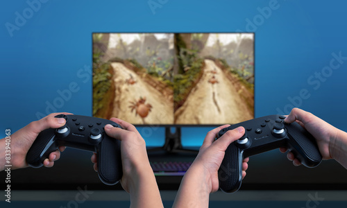 Quadro su tela Two players using gamepads, playing a game on a computer with a split-screen display