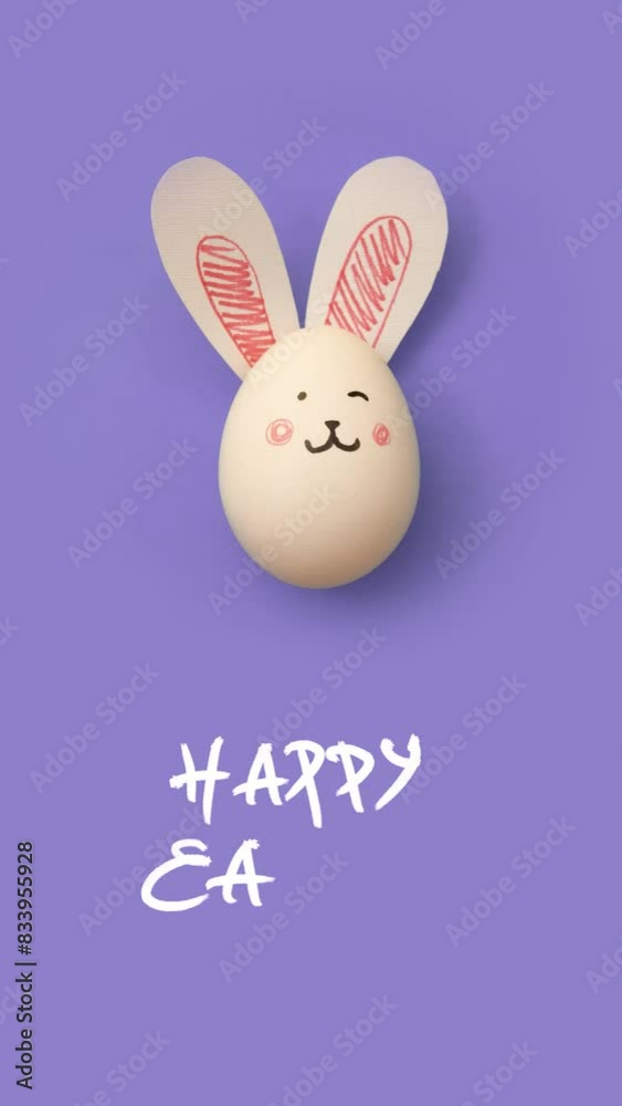 Vertical 4K animated video. Frame-by-frame, stop motion animation. Top view. White chicken egg with cute bunny face and rabbit ears on purple background for religious holiday Happy Easter. Magic. Food Vertical 4K animated video. Frame-by-frame, stop motion animation. Top view. White chicken egg with cute bunny face and rabbit ears on purple background for religious holiday Happy Easter. Magic. Food