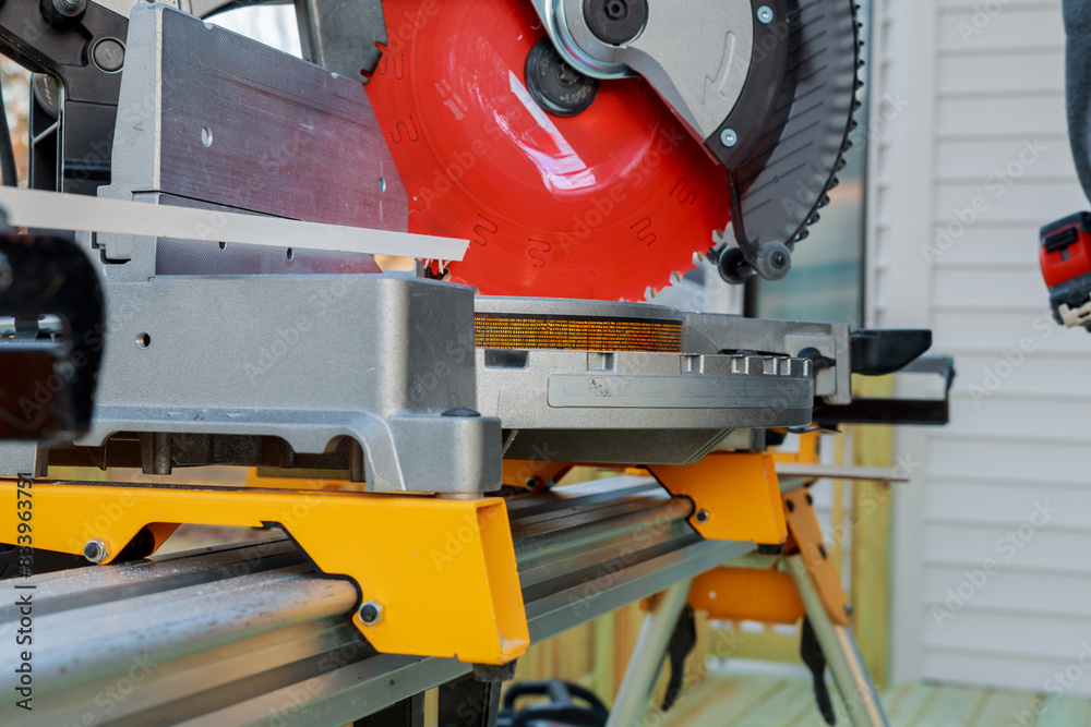 Using circular saw, contractor cuts wooden moldings before installing them Using circular saw, contractor cuts wooden moldings before installing them