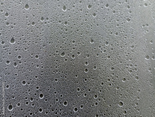 Water drops on the glass surface. Condensation on transparent surfaces. Texture of water drops and steam on the glass surface.