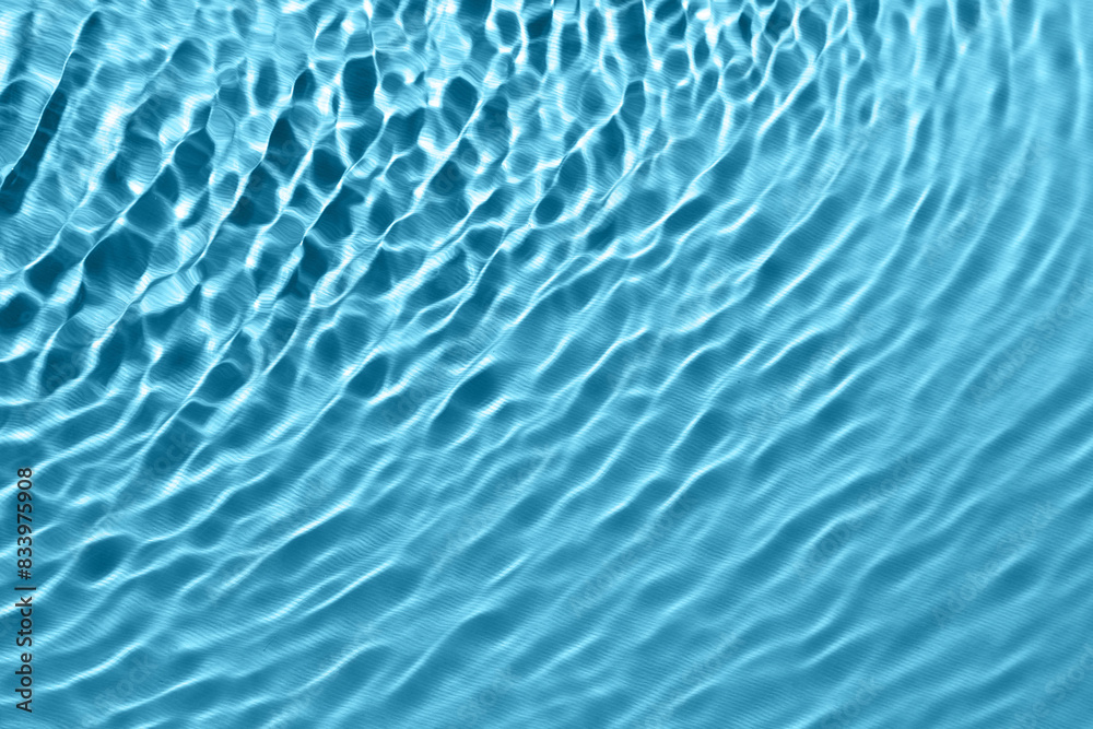 Rippled surface of clear water on light blue background, top view Rippled surface of clear water on light blue background, top view