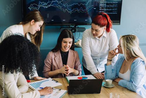 Young students learning economy and finances on college project. Group of girls creating a startup