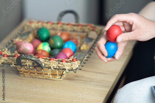 easter egg tapping, mother and son egg tapping next to basket with easter eggs, selective focus, close up of hands egg tapping