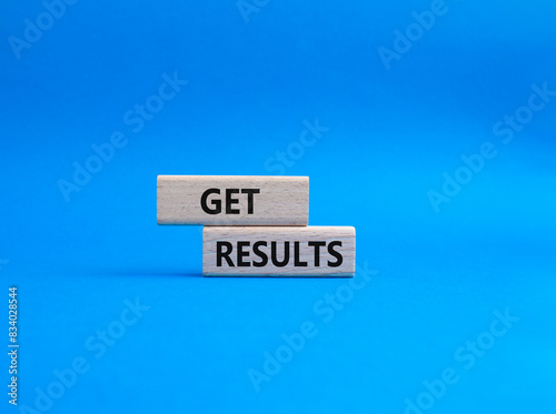 Get results symbol. Wooden blocks with words Get results. Beautiful blue background. Business and Get results concept. Copy space.