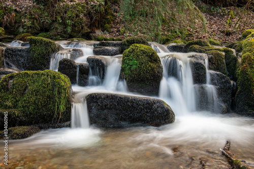 Long exposure of a waterfall flowing through the woods at Combe Park near Watersmeet in Exmoor National Park