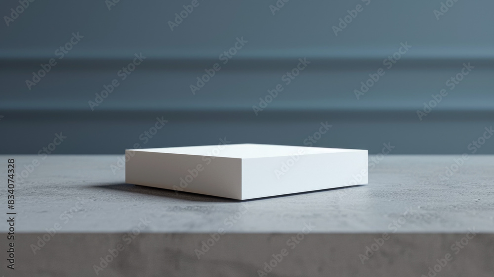 A white box sits on a grey table A white box sits on a grey table