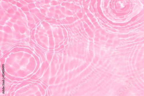 circles and drops on pink water. pink water surface with ripples and rings. abstract pink background with circles. 