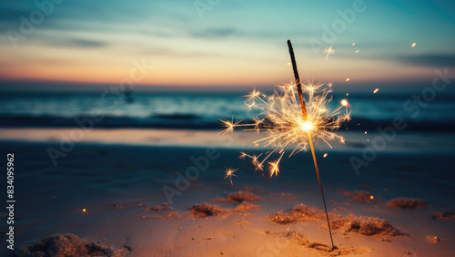 Fototapeta Naklejka Na Ścianę i Meble -  Single sparkler on a beach at sunset

