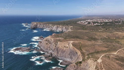 Vast panoramic view of the high cliffs and Atlantic Ocean near Arrifana, Portugal photo