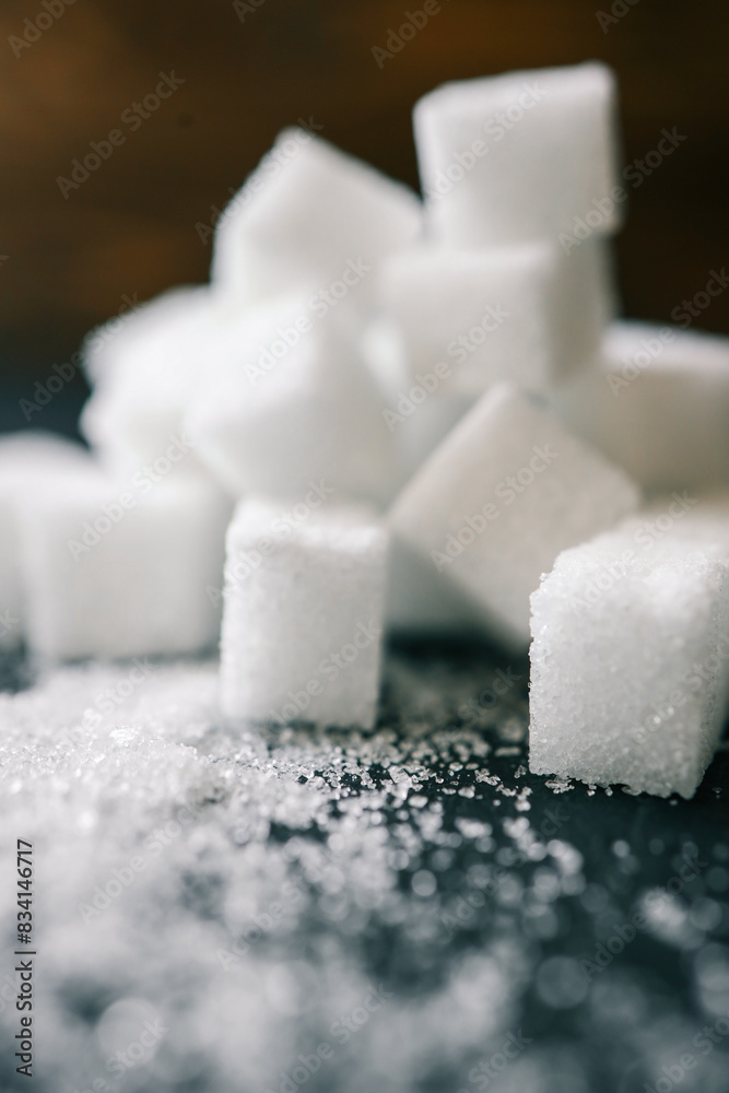White crystal sugar cubes on black background White crystal sugar cubes on black background