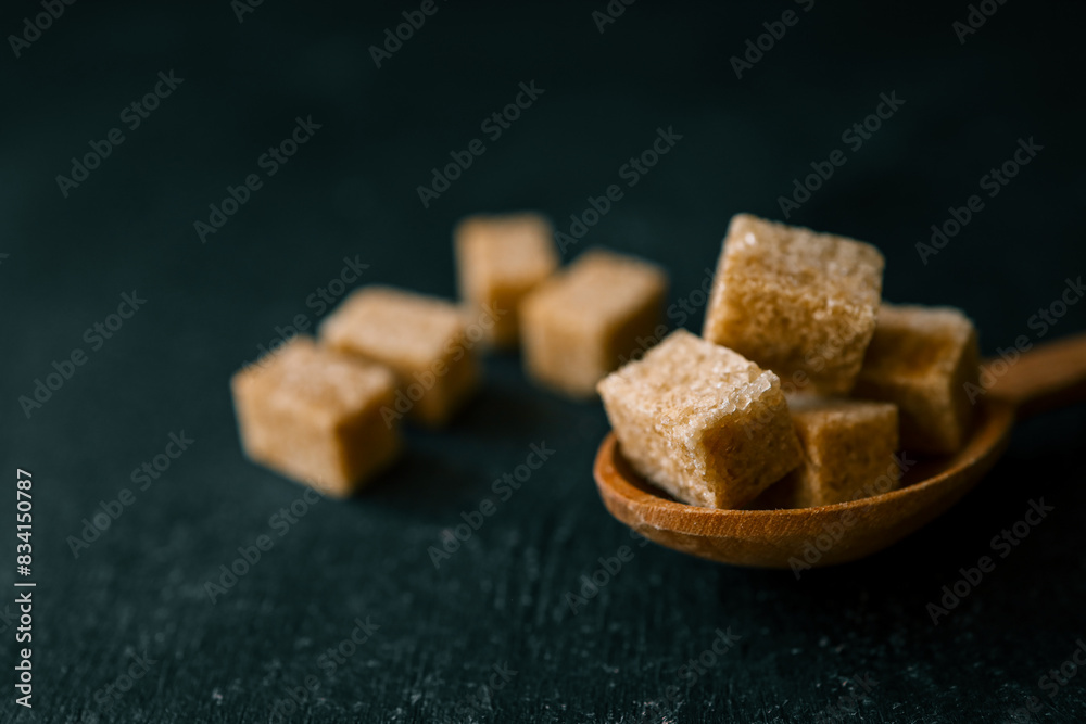 brown sugar heap and wooden spoon brown sugar heap and wooden spoon