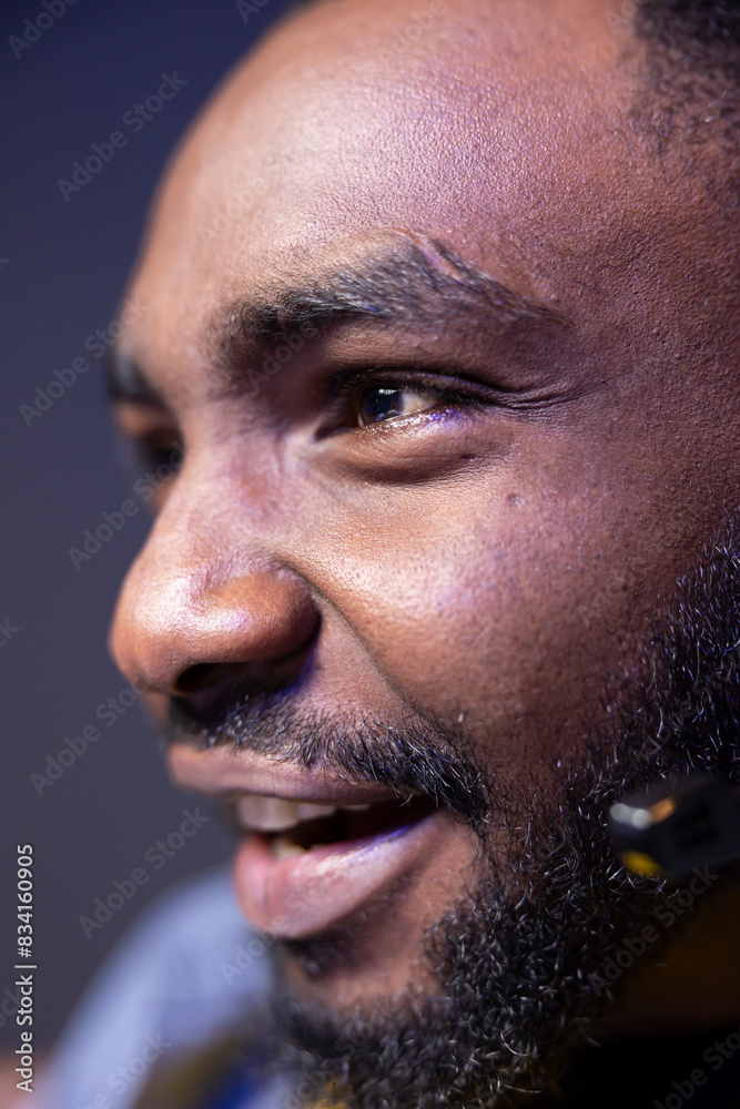 Obraz premium Ecstatic african american gamer having fun in gaming room, playing videogames on computer. Extreme close up shot of excited BIPOC esports player performing in gaming tournament from home late at night