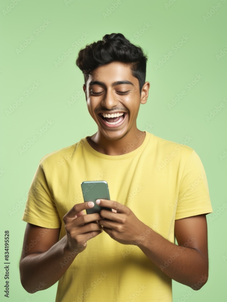 A person smiling while looking at their cellphone A person smiling while looking at their cellphone