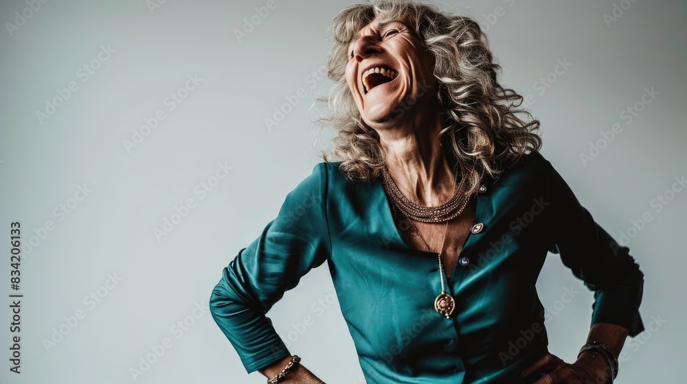 A woman smiling and laughing with her hands on her hips, perfect for use in social media posts or as a illustration for humor-related content A woman smiling and laughing with her hands on her hips, perfect for use in social media posts or as a illustration for humor-related content
