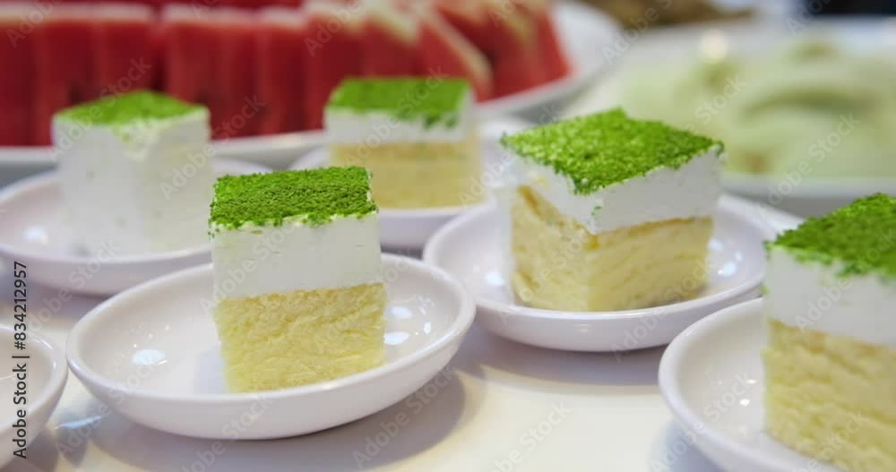 pistachio sponge cake at the buffet table sprinkled with green freeze-dried pistachio berries pistachio sponge cake at the buffet table sprinkled with green freeze-dried pistachio berries