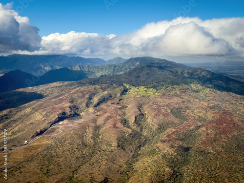 Aerial view of Hawaiian island of Oahu  with Nanakuli Forest Reserve in the background against blue sky with clouds photo