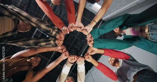 People, teamwork and fist bump in circle for support with trust, partnership and collaboration from below. Friends, hands and emoji for solidarity with team building, goals and power with low angle photo