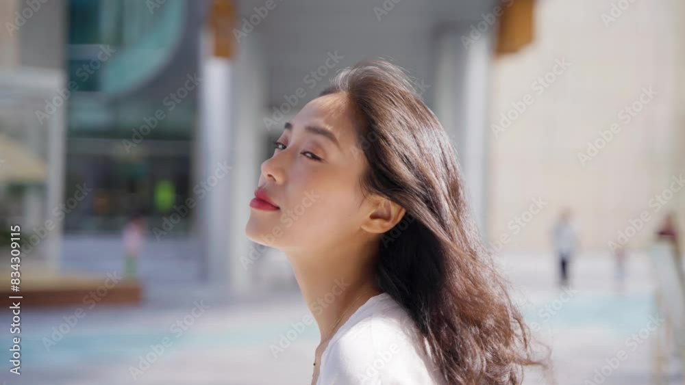 charming young lady looking at camera smile in the summer morning sunlight at urban city street