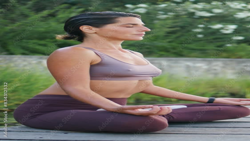 Sport lady practice online yoga at summer vertical. Woman lotus pose meditation Sport lady practice online yoga at summer vertical. Woman lotus pose meditation