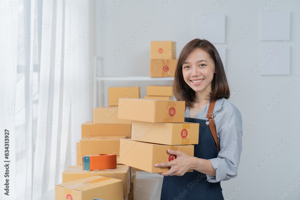 SME entrepreneur Small business entrepreneurs Online selling ideas, Happy Asian business owner work on computer and a box at home, delivery SME procurement package box deliver to customers, SME entrepreneur Small business entrepreneurs Online selling ideas, Happy Asian business owner work on computer and a box at home, delivery SME procurement package box deliver to customers,