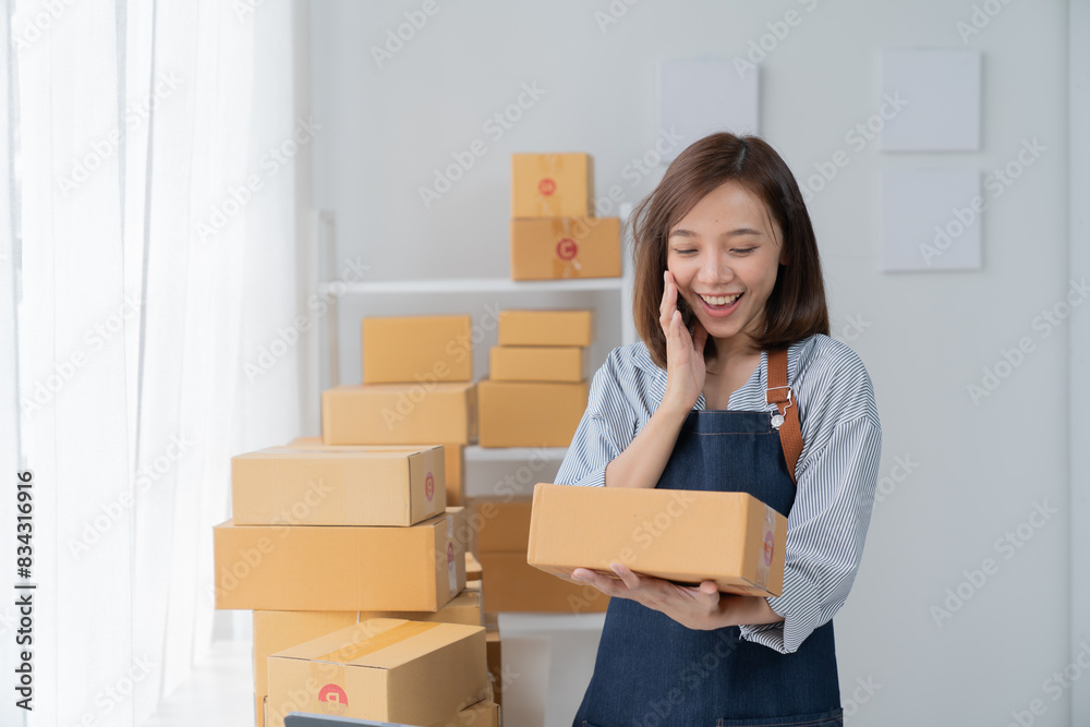 SME entrepreneur Small business entrepreneurs Online selling ideas, Happy Asian business owner work on computer and a box at home, delivery SME procurement package box deliver to customers, SME entrepreneur Small business entrepreneurs Online selling ideas, Happy Asian business owner work on computer and a box at home, delivery SME procurement package box deliver to customers,