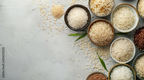 Assortment of raw rice varieties in dishes on a neutral surface Overhead shot with room for text flat lay composition