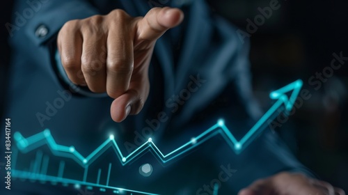 Business man pointing upward growth graphic line with arrow, showing business growth and success concept on virtual screen background.