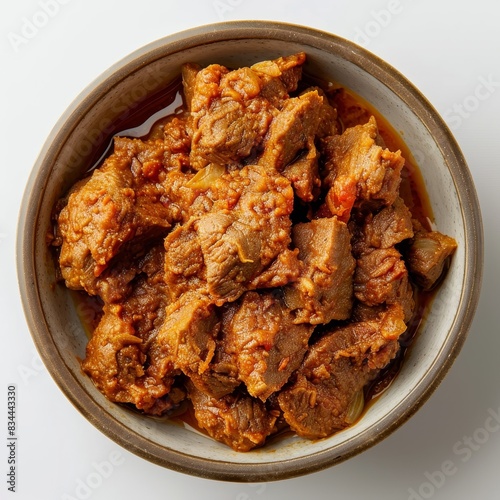 Top view of rendang from Indonesia, isolated on white background photo