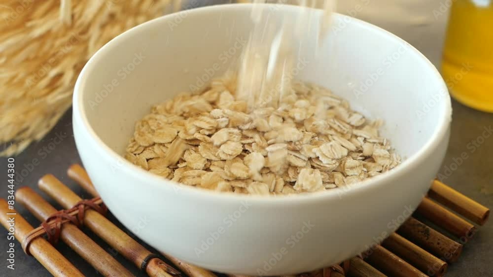 slow motion of falling roasted oats flakes in a bowl slow motion of falling roasted oats flakes in a bowl