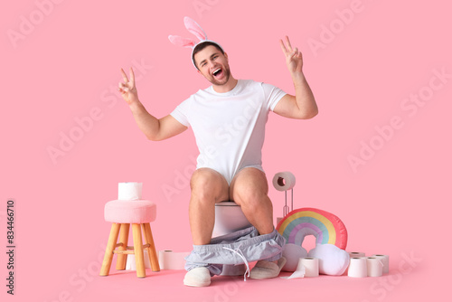Young man in bunny ears sho...