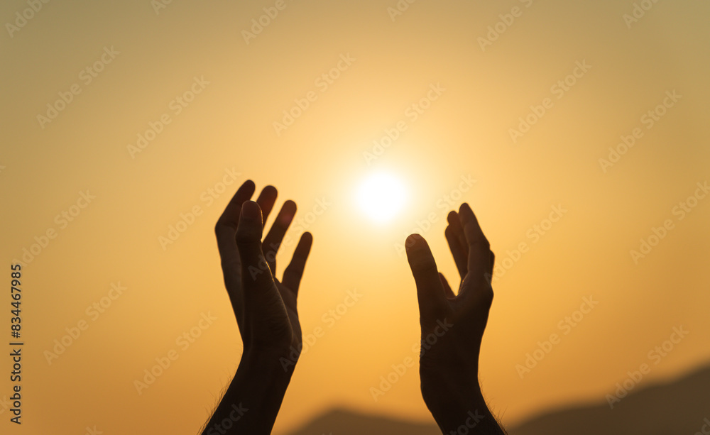 Closeup hands praying for blessing from god during sunset background. Hope and freedom concept. Closeup hands praying for blessing from god during sunset background. Hope and freedom concept.