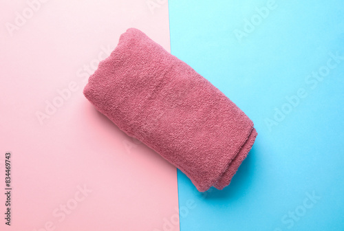 Roll of towel on blue pink background. Top view