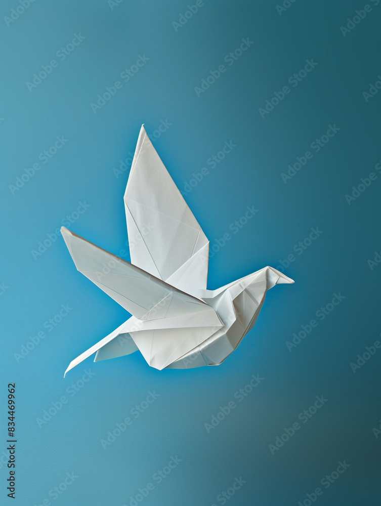 White bird made of paper, origami. Blue background. Bird as a symbol of peace, dove of peace. International day of peace. Peaceful sky. White bird made of paper, origami. Blue background. Bird as a symbol of peace, dove of peace. International day of peace. Peaceful sky.