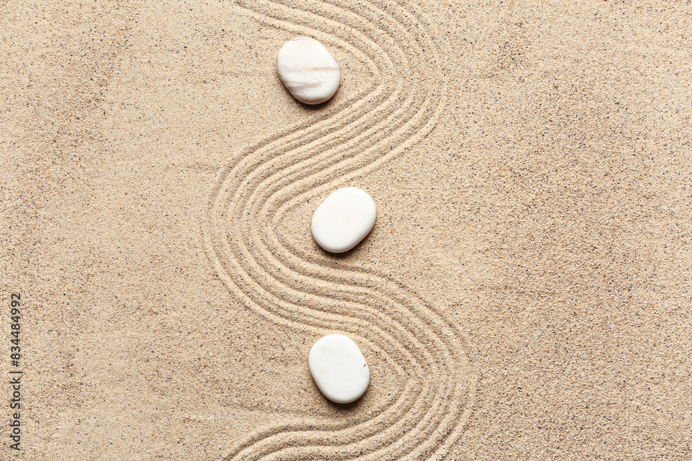 White stones on sand with lines. Zen concept