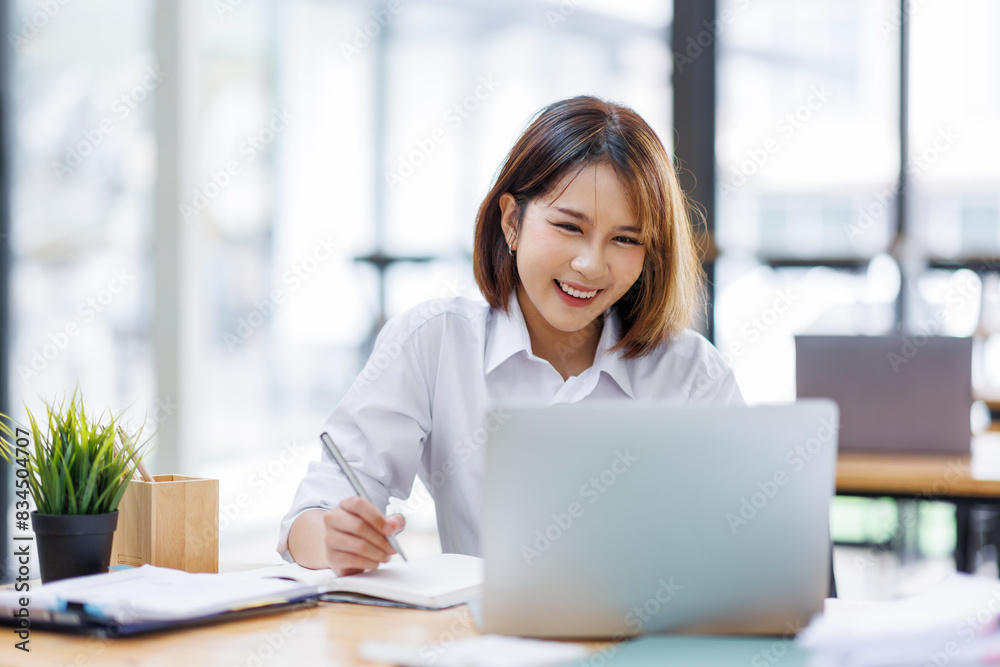 Portrait of happy asian female employee at computer Portrait of happy asian female employee at computer