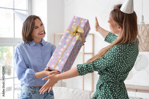 Young woman giving her frie...